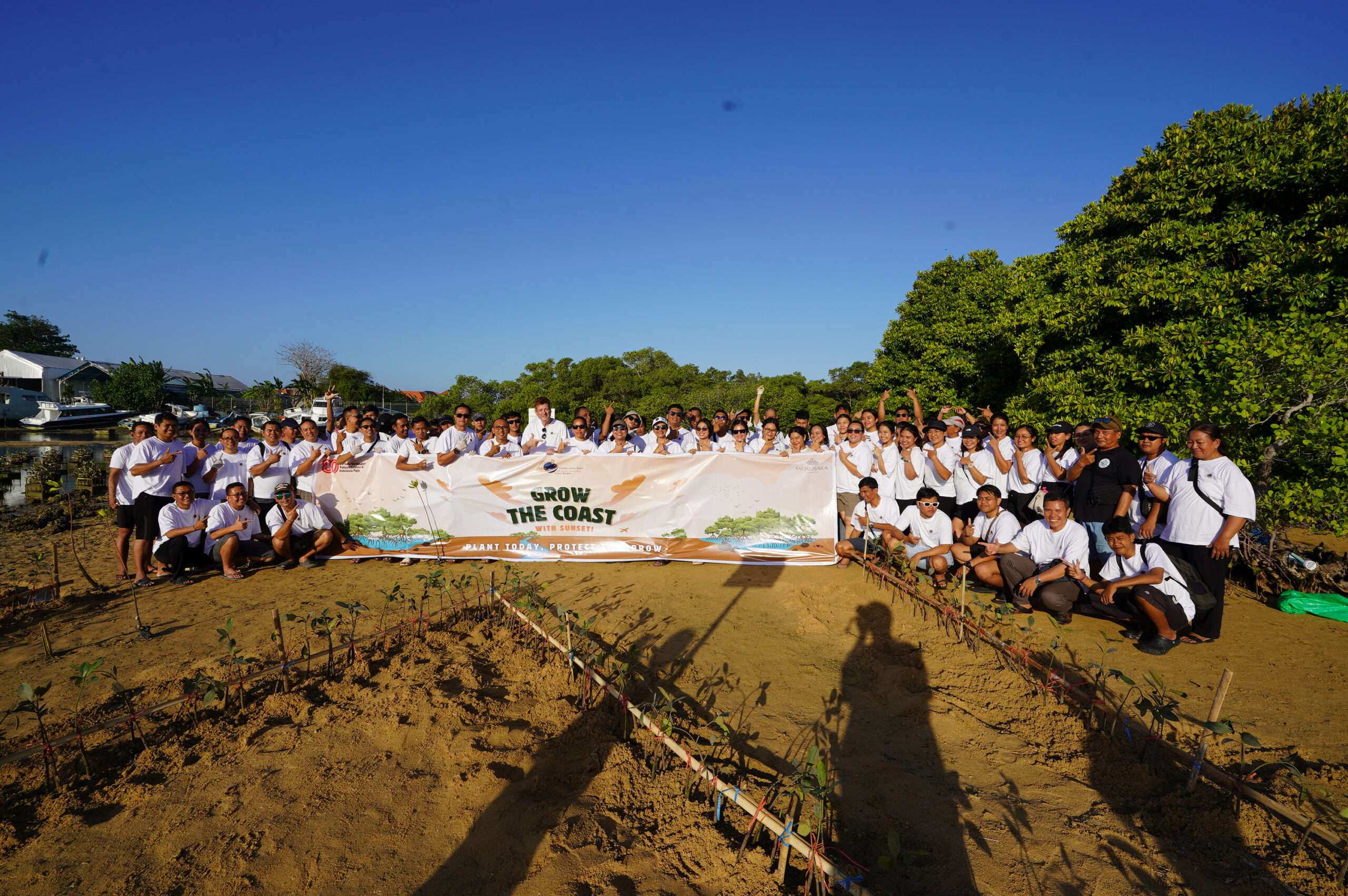 The Merusaka Nusa Dua team posing for a group photo after successfully planting mangrove saplings during the 'Grow The Coast' CSR event.